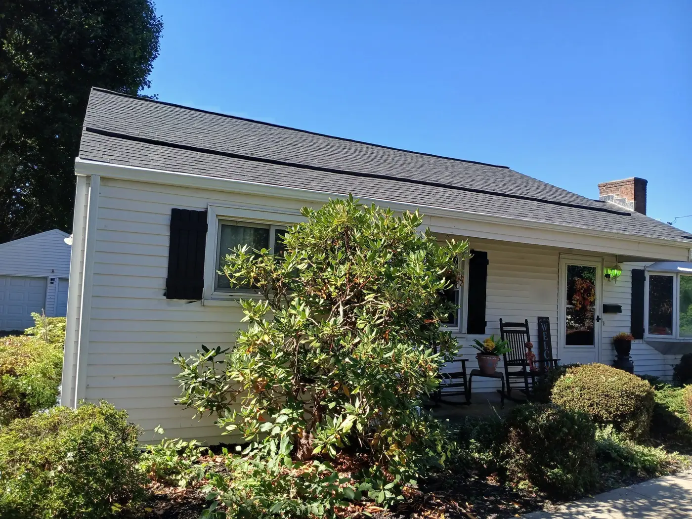 White house with a new Onyx Black Owens Corning Duration roof